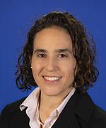 Professional headshot of person wearing a black suit jacket