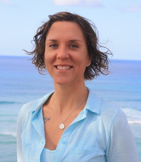 Laci M. Gerhart-Barley smiling in front of a water background